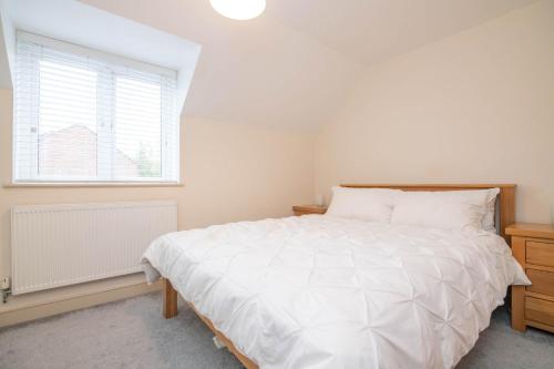 a bedroom with a large white bed and a window at Vine Mews - 2 Bed in Warwick
