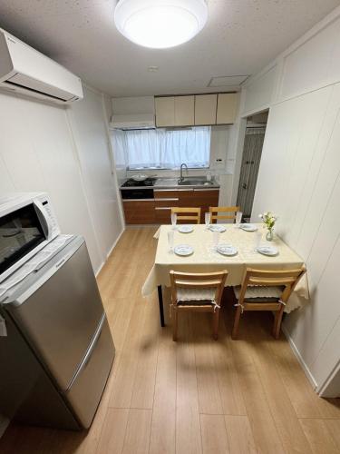 a kitchen and dining room with a table and chairs at 6 minutes to Shinjuku, 10 minutes to Shibuya, accommodating 6 people in Tokyo