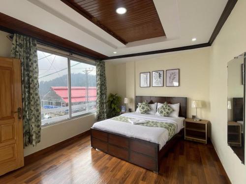 a bedroom with a bed and a large window at Umda Hotel Galaxy in Dargai