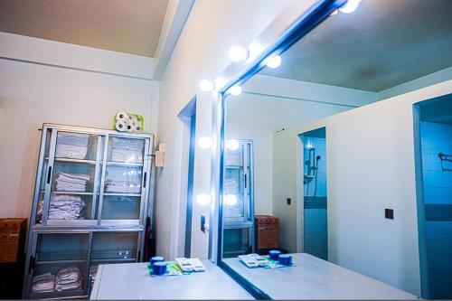a bathroom with a large mirror and a sink at Angkor Sunshine Oasis in Siem Reap