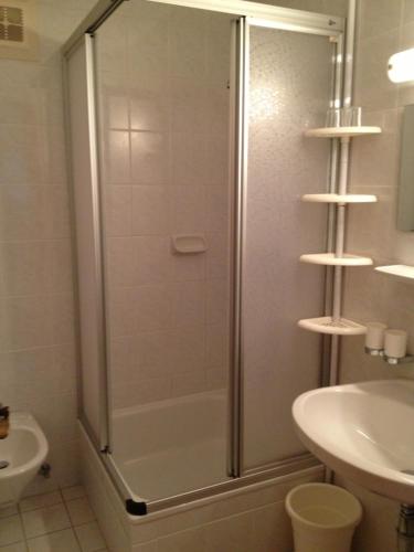 a shower with a glass door in a bathroom at Pension & Appartement Fortin in Bad Kleinkirchheim
