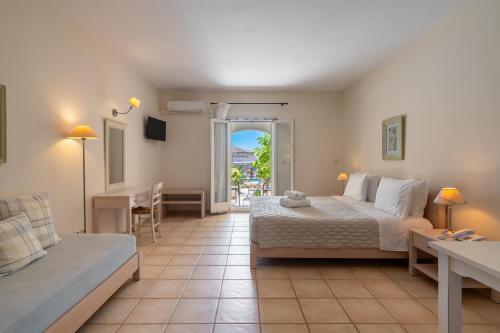 a living room with a bed and a couch at Aeolos Hotel in Koufonisia