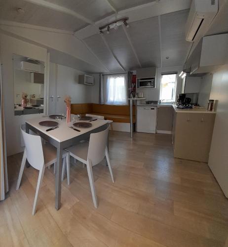 a kitchen and dining room with a table and chairs at mobilhome 508 in Parentis-en-Born