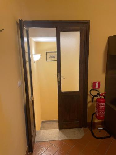 an open door in a room with a fire extinguisher at Torre Verde Acquapendente in Acquapendente