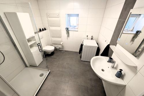 a bathroom with a sink and a shower and a toilet at Modern Apartment Bedburg-Hau in Bedburg Hau