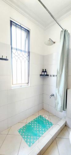 a bathroom with a shower with a glass door at Pahali Kati 3 Bedroom Apartment in Nyali in Bamburi