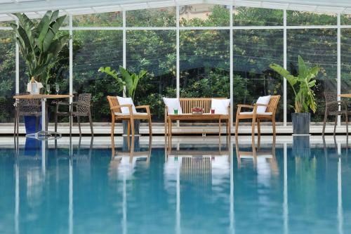 a patio with chairs and a table and a pool at Hotiday Gallipoli Centro in Gallipoli