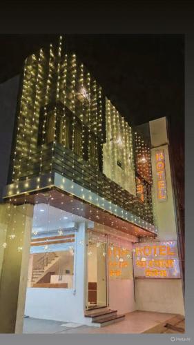 a view of a hotel with a tall building at Hotel Shree Shyam Palace in Ujjain