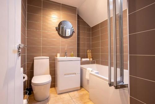 une salle de bain avec toilettes, lavabo et baignoire dans l'établissement Taylor Cottage, à St Andrews