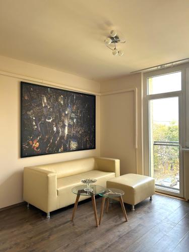 a living room with a couch and a table at Szántó Prime Residence in Szolnok