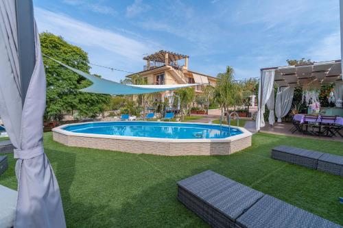 a swimming pool in the yard of a house at La Casa Del Vagabondo in Belvedere