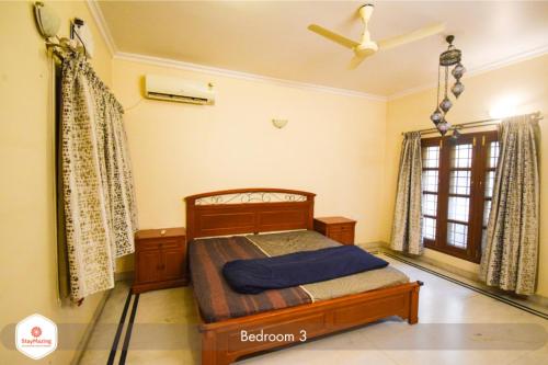 a bedroom with a bed and a ceiling fan at Staymazing Ferndale-1 & 2 BHK Boutique AC Serviced Apartments in Bengaluru