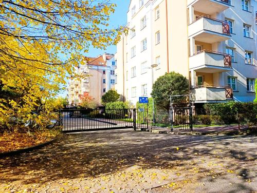 a black gate in front of a building at Kolory Warmii Apartament Niebieski in Olsztyn