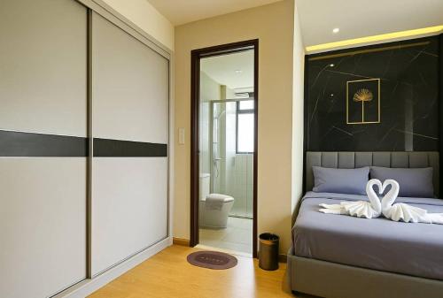 a bedroom with a bed with towels on it at Danga Bay The Lexus Seaview 3BR 8Pax Balcony by Our Stay in Johor Bahru