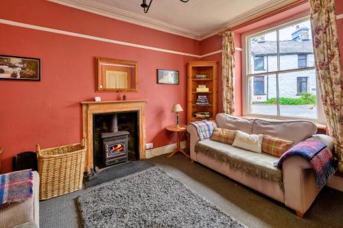 a living room with a couch and a fireplace at Finest Retreats - Bod Gwynedd in Penmachno