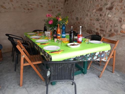 a table with plates of food and bottles of wine at Cà Romi in Volta Mantovana