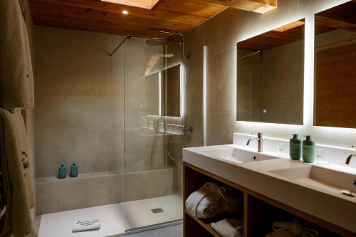 a bathroom with a shower and a sink and a tub at Hôtel Les Roches Fleuries in Cordon