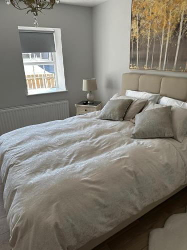 a large bed in a bedroom with a window at Joe McGarrity Homestead in Carrickmore