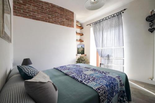 a bedroom with a bed and a window at Maison La Tur in Almese