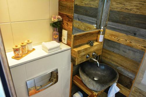 a bathroom with a sink and a counter with a mirror at Apartment mitten in Rosenheim in Rosenheim