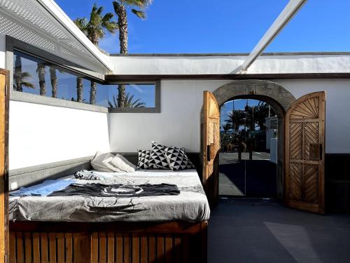 a bedroom with a bed and an open door at Casita Malvika in Costa Teguise