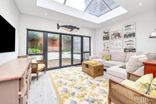a living room with a couch and a tv at GROUND floor apartment no steps 119 Northgate St luxury 2 bedroom apartment close to the town centre with paid parking close by in Bury Saint Edmunds