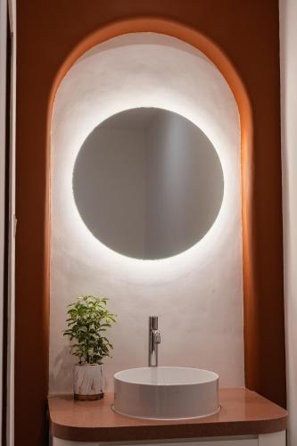 a bathroom with a sink and a mirror at Omar Hotel in Tangerang