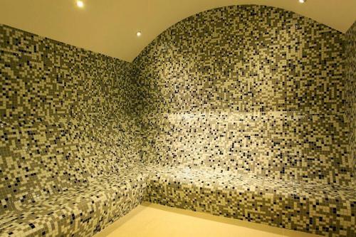 a room with a wall covered in mosaic tiles at Modern Comfort Steps from Taksim in Istanbul