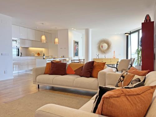 a living room with two couches and a kitchen at Lady Delmar Marina Olhao By Junto ao Mar in Olhão
