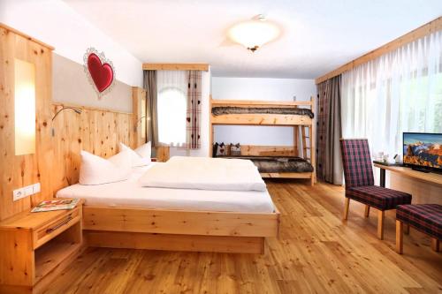a hotel room with a bed and a desk at Aktivhotel Waldhof in Oetz