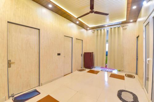 an empty room with doors and a ceiling at FabHotel Doon Classic Homestay in Dehradun