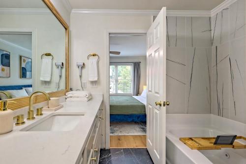 a bathroom with two sinks and a large mirror at Downtown Helen Walk To Shops And Restaurants in Helen