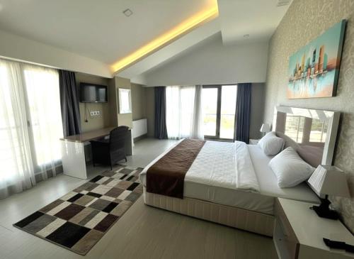 a hotel room with a large bed and a desk at Diplomat Suites in Baku