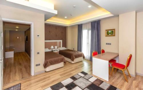 a hotel room with two beds and a desk at Diplomat Suites Hotel in Baku