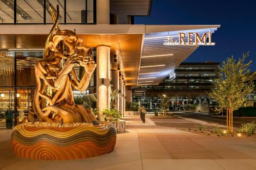 a statue in front of a building at night at The REMI Scottsdale Autograph Collection in Scottsdale