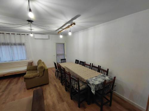a dining room with a table and a chair at El Salón de Arriba in El Real de San Vicente