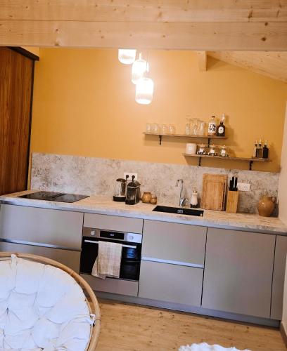 a kitchen with a stove and a counter top at Chalet romantique & bucolique in Montignac-Charente