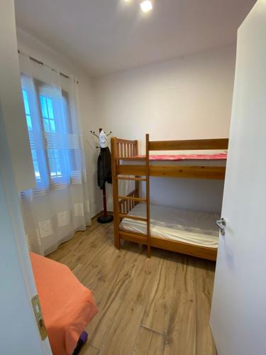 a room with two bunk beds and a window at Vila Blue River in Orikum