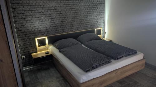 a bed in a room with two pillows on it at " FeWo am Hof " Große Wohnung mit zwei Schlafzimmern, seperate Küche und großem Bad in Beverstedt