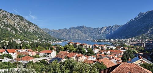 a view of a town with a lake and mountains at Aky apartment in Škaljari