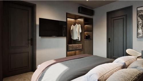 a bedroom with a bed and a flat screen tv at Alkioni Boutique Hotel in Pýli
