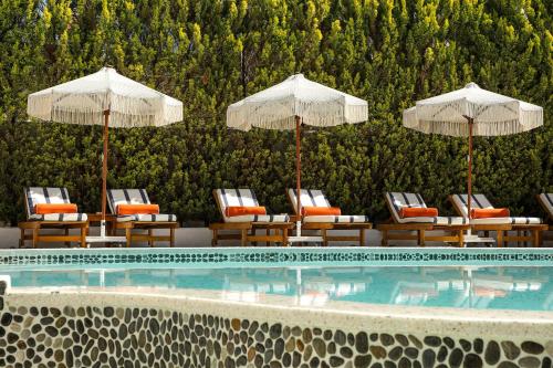 a swimming pool with chairs and umbrellas at Kassandra Boutique Hotel in Oludeniz