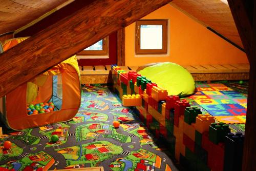 a childs room with a bed with a toy train on the floor at Bayerische Gastwirtschaft Dimpfl-Stadl in Lam