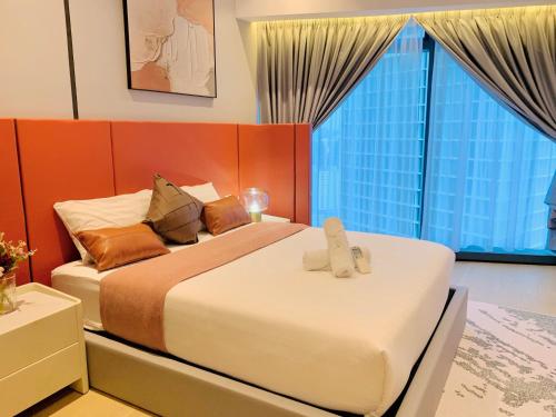 a bedroom with two beds and a large window at Eaton Residences By Classic in Kuala Lumpur