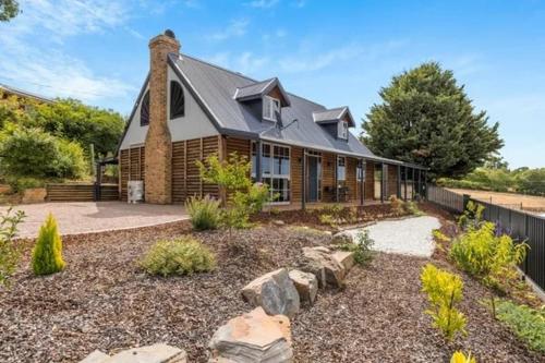 a large house with a gambrel roof at Hahndorf Log Cabin in Hahndorf