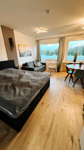 a bedroom with a bed and a living room at FeWo Markert in Burgtiefe auf Fehmarn 