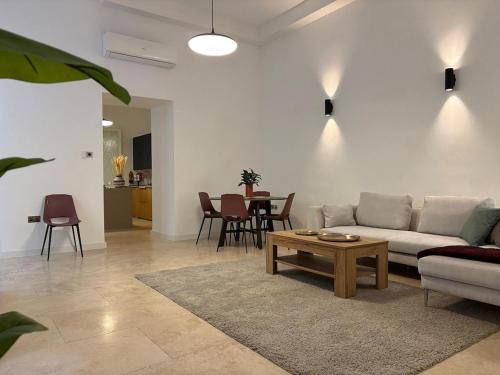 a living room with a couch and a table at St Ursula Sanctuary 3 Bed Valletta in Valletta