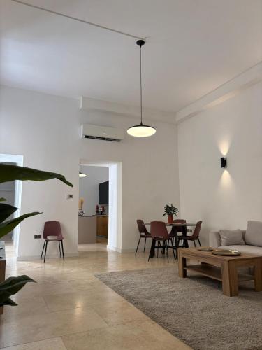 a living room with a couch and a table at St Ursula Sanctuary 3 Bed Valletta in Valletta