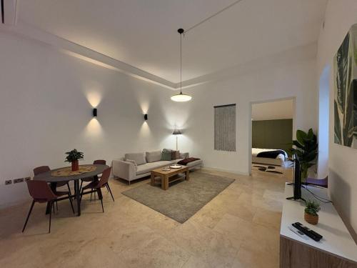 a living room with a couch and a table at St Ursula Sanctuary 3 Bed Valletta in Valletta