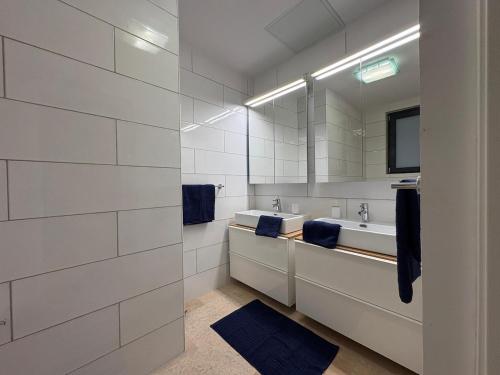 a bathroom with two sinks and a mirror at St Ursula Sanctuary 3 Bed Valletta in Valletta